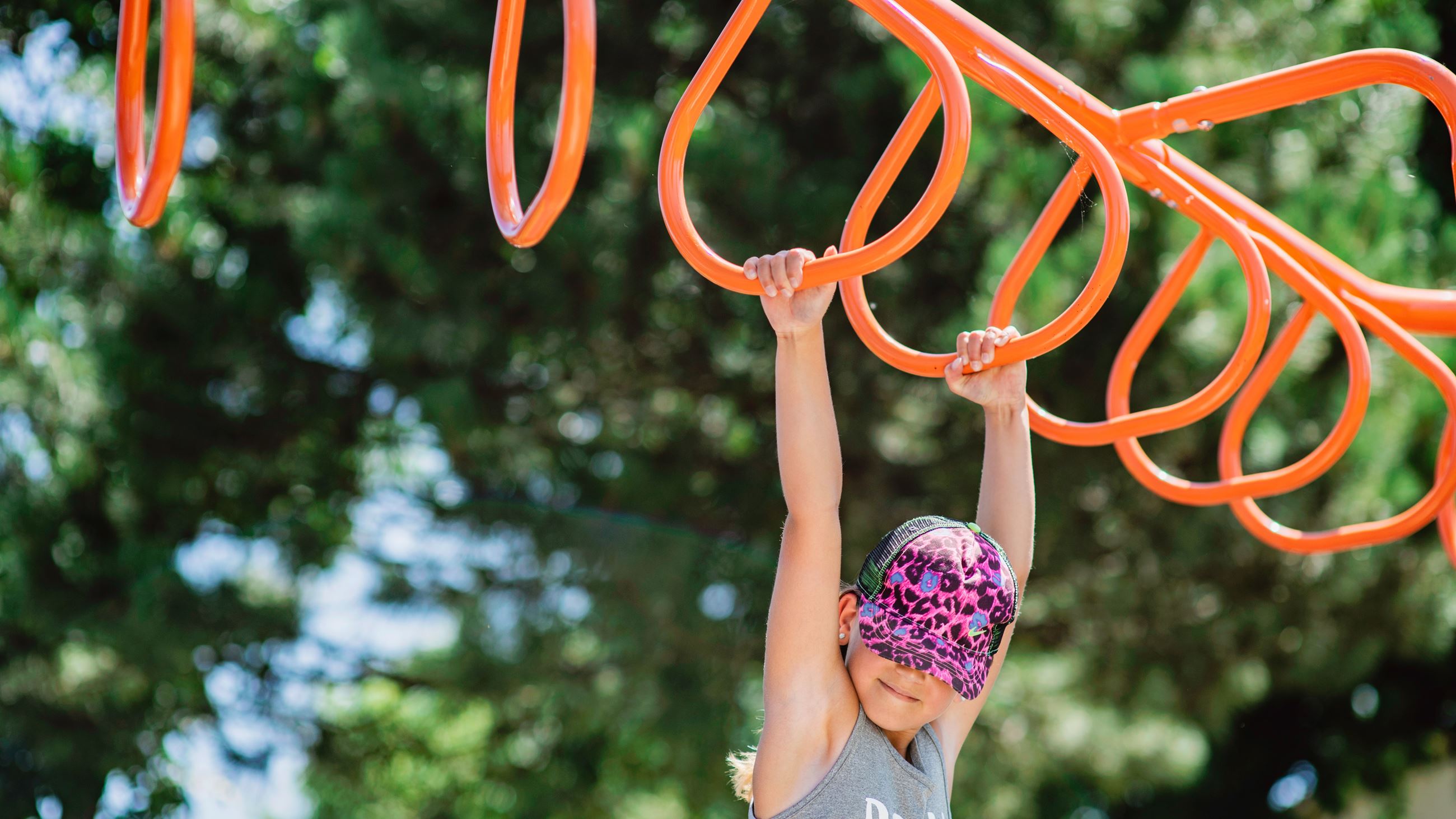 child playing on monkey bars